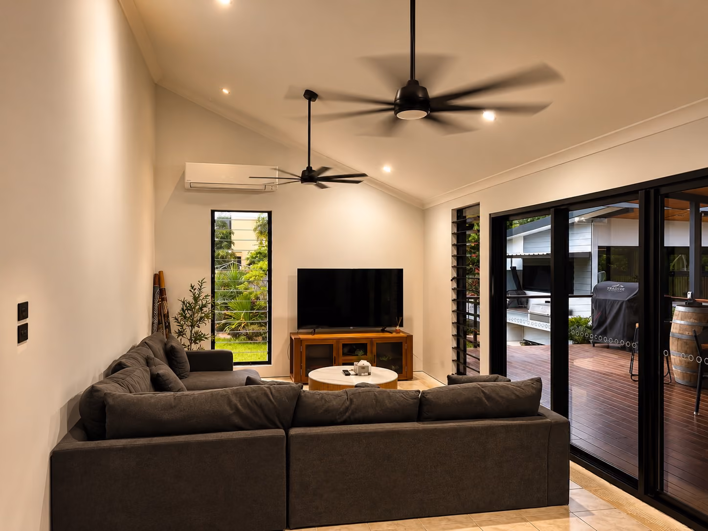 Renovated living area with updated finishes and sliding glass doors connecting to the outdoor deck.