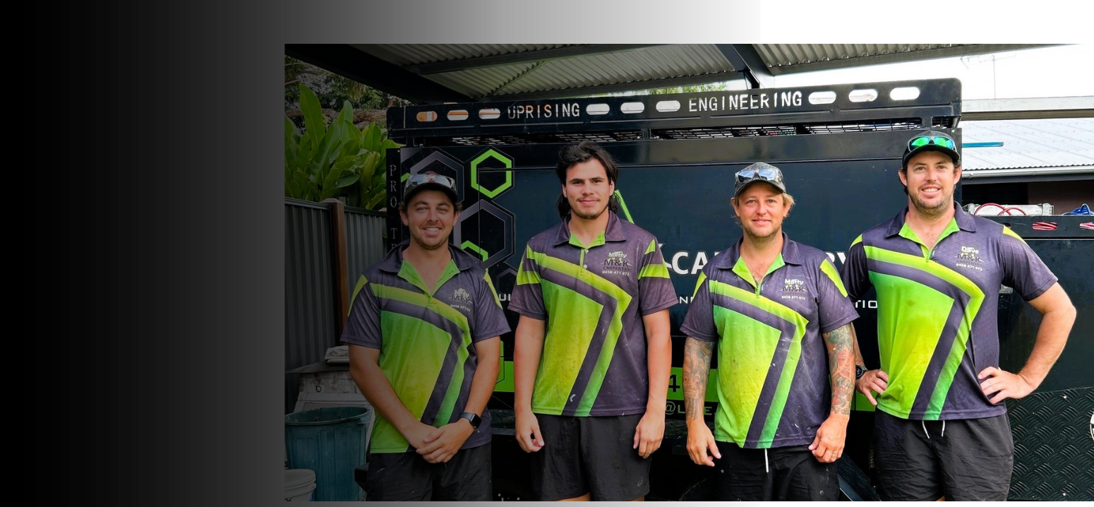 M&K Carpentry team beside their branded work vehicle in Darwin