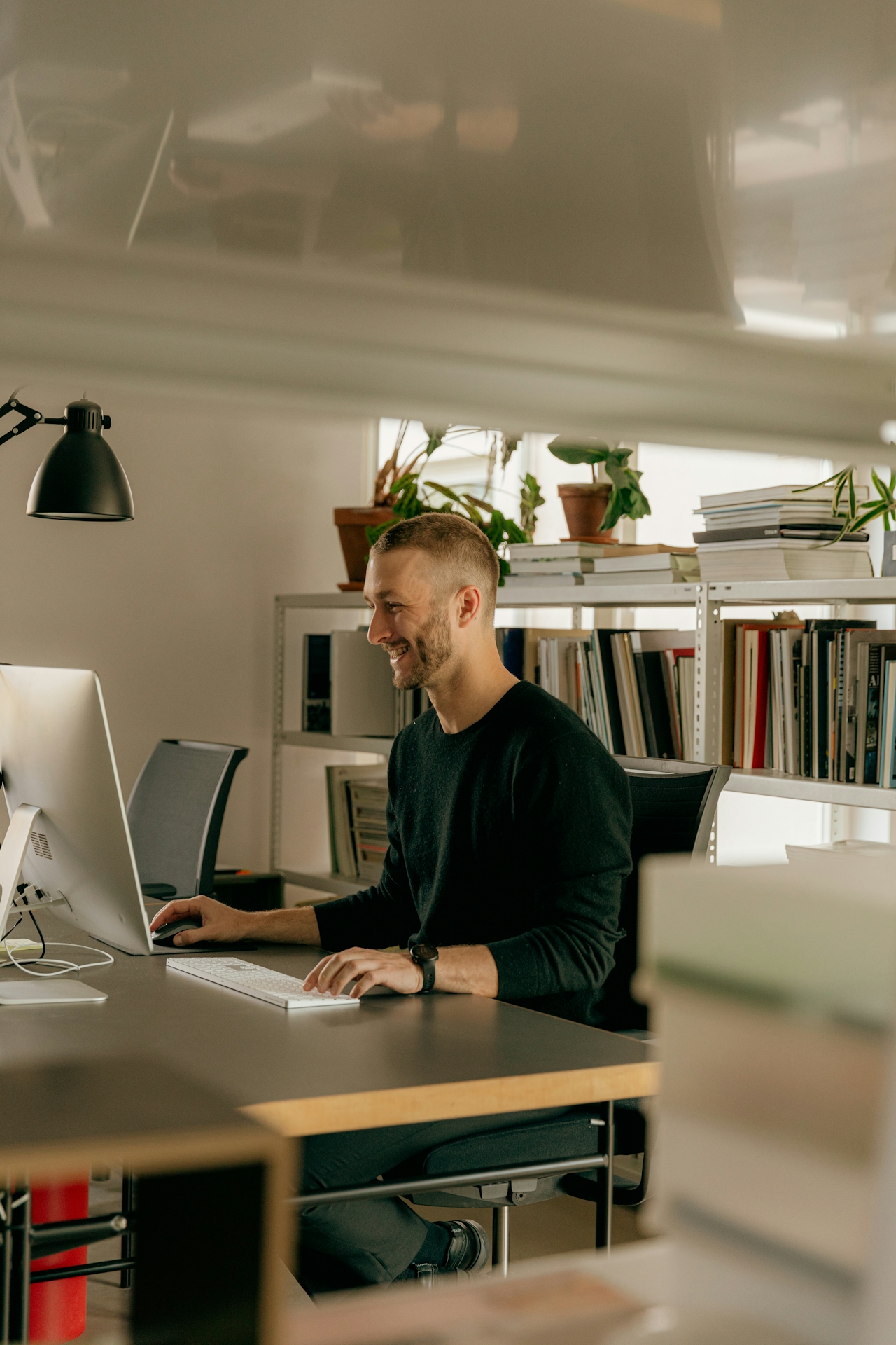 An IT professional working at a computer in a modern office