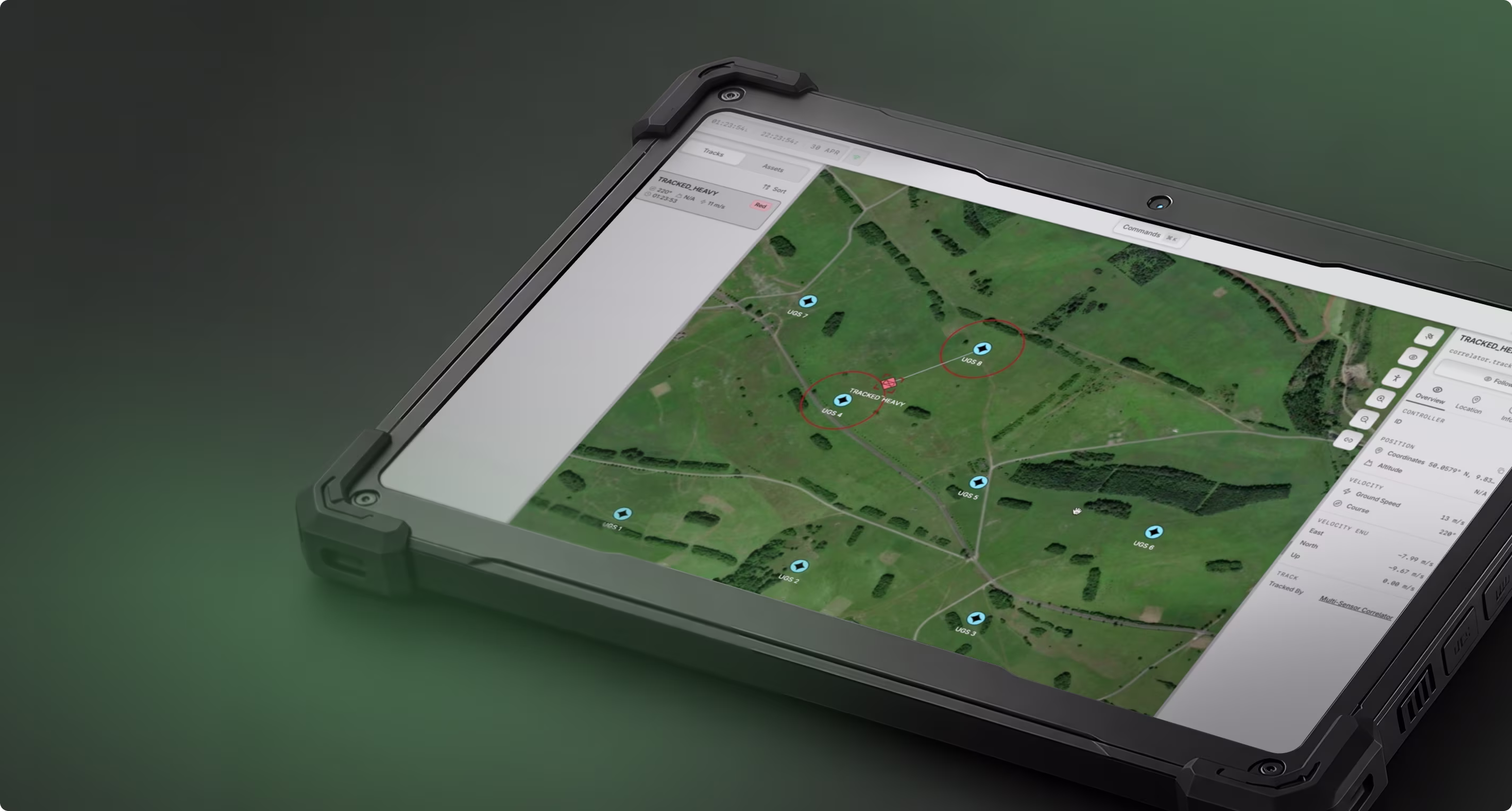 Tablet showing a green terrain map with tracked drones labeled UGS and a red marker labeled TRACED_HEAVY.