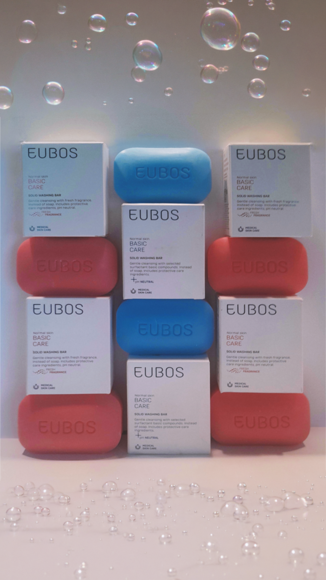 Eubos soap packaging and soap bars arranged with floating bubbles.