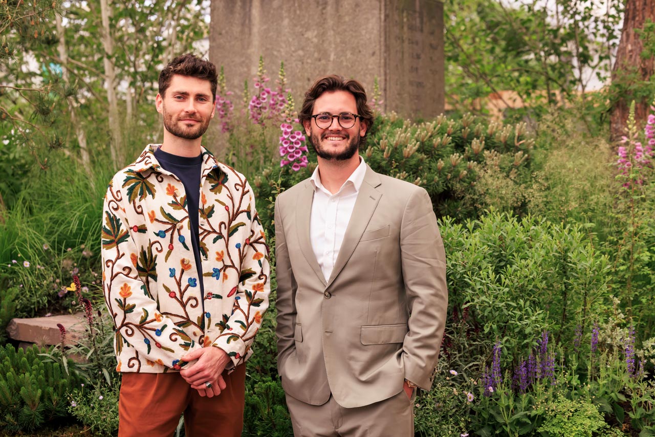 Oliver Gregson of Hardwood Landscapes, right, with a colleague in front of foxgloves and mixed planting at the Chelsea Flower Show