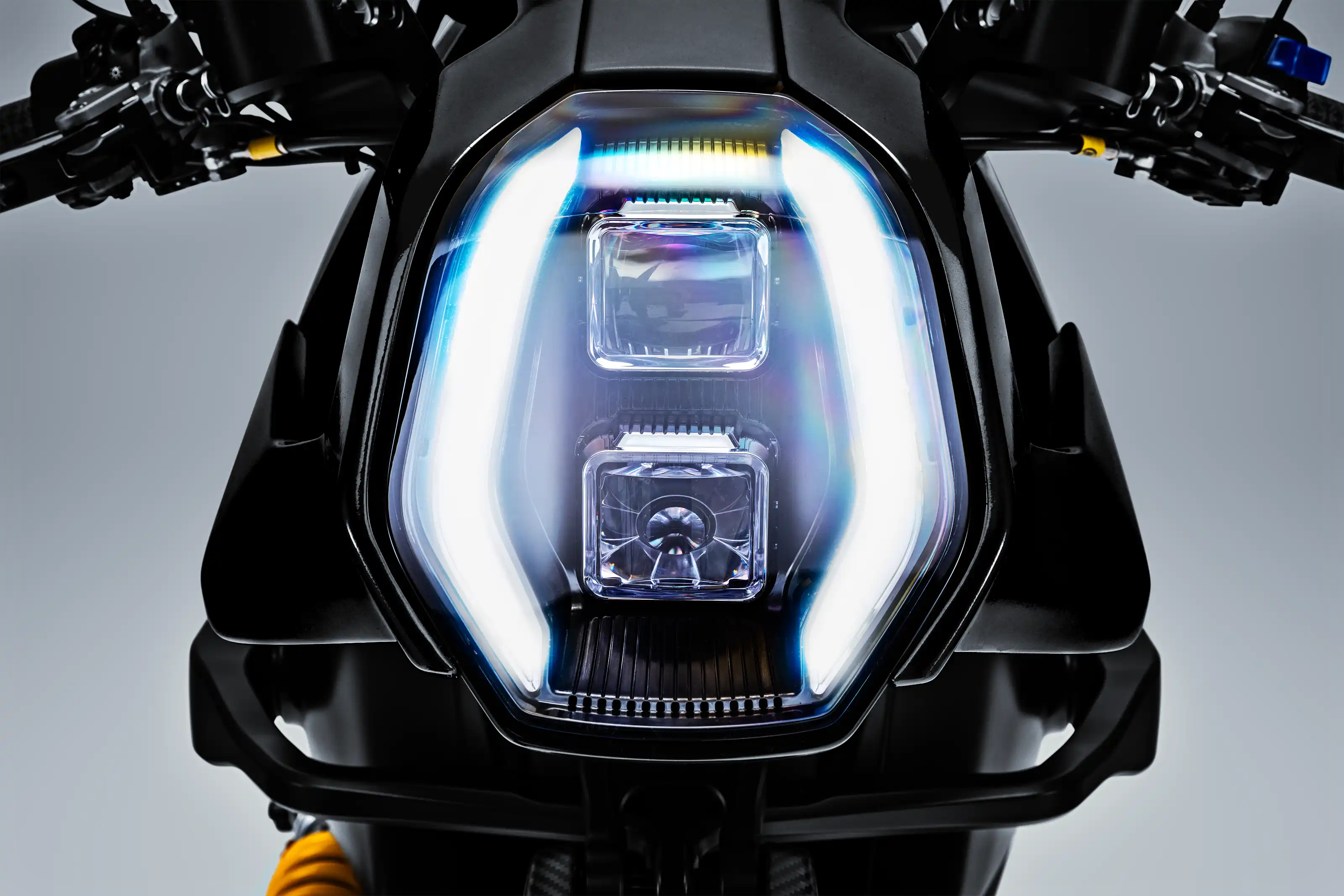Arc Vector electric motorcycle detail showing integrated LED headlights
