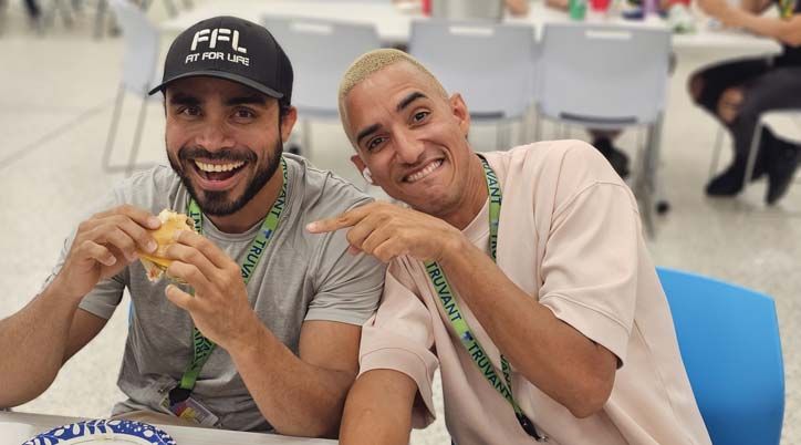 Two Truvant employees smiling at a table
