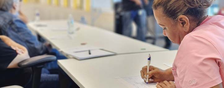 Employees taking notes during a training session