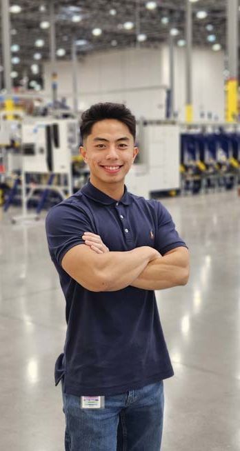 A Truvant team leader standing with arms crossed on the warehouse floor