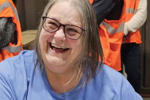 A smiling Truvant employee in a high-visibility vest