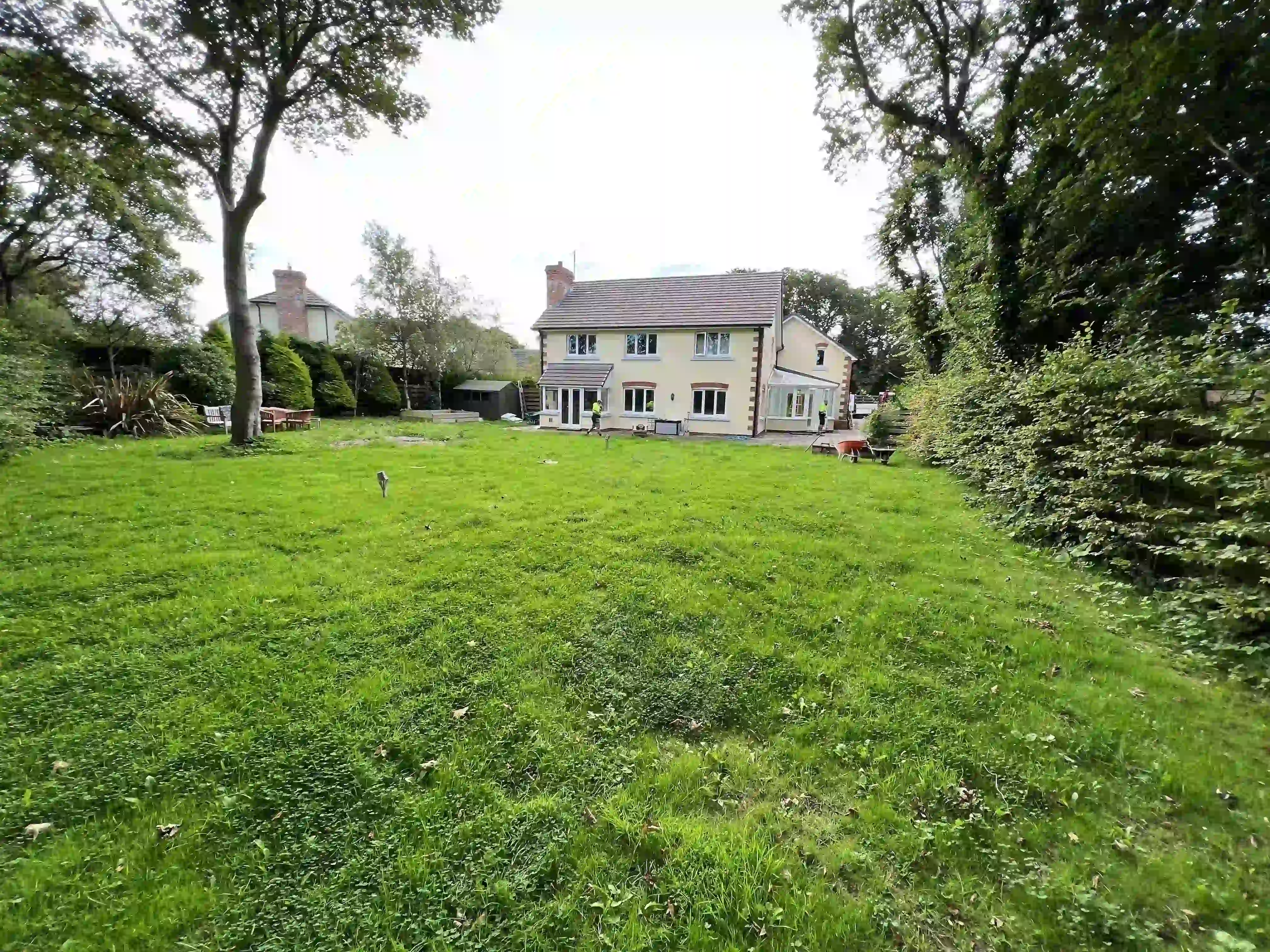Rear lawn and house before the garden transformation at 15 The Links, Peel