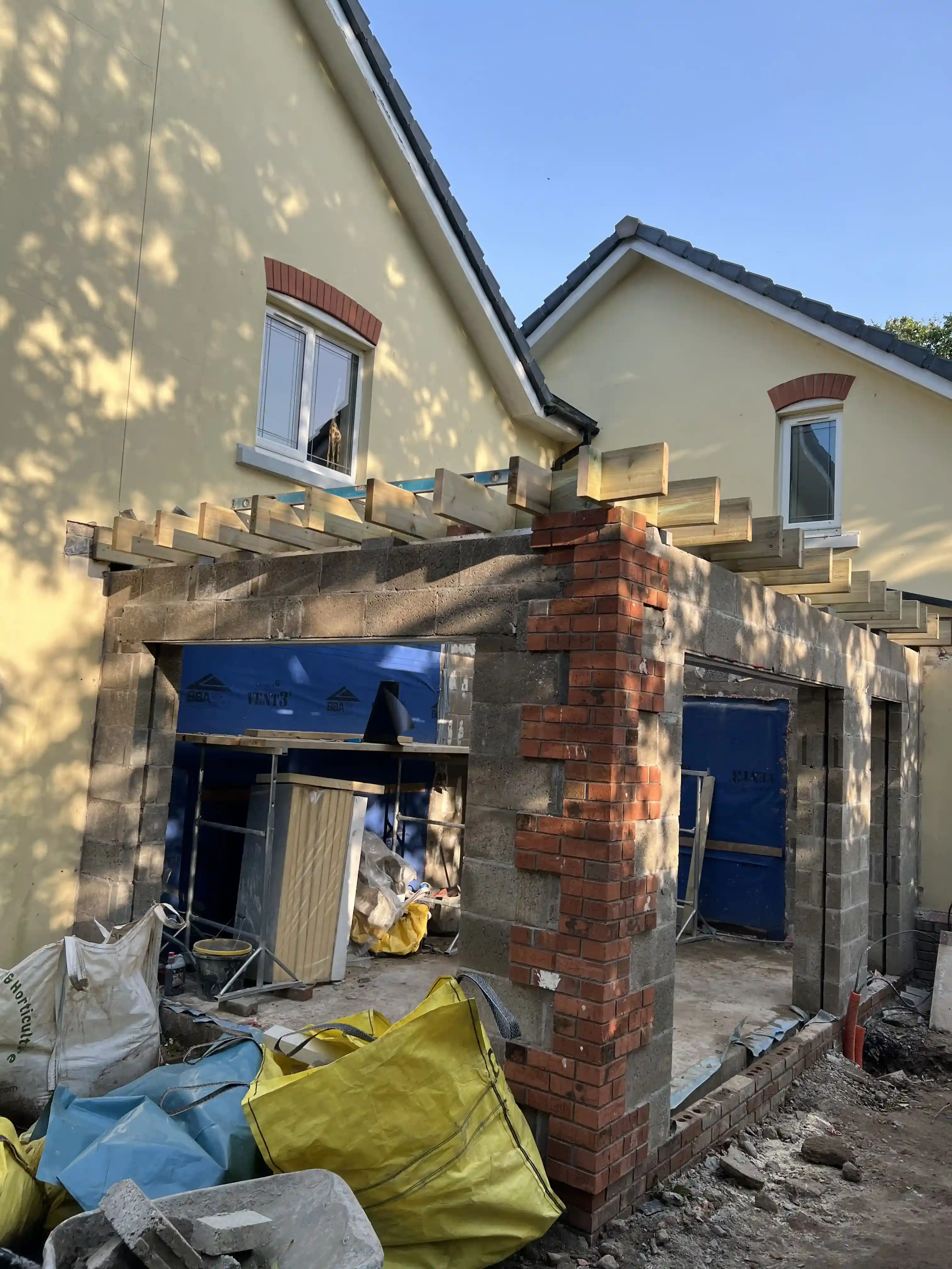 Blockwork and brick piers of the new sunroom extension during construction at 15 The Links, Peel