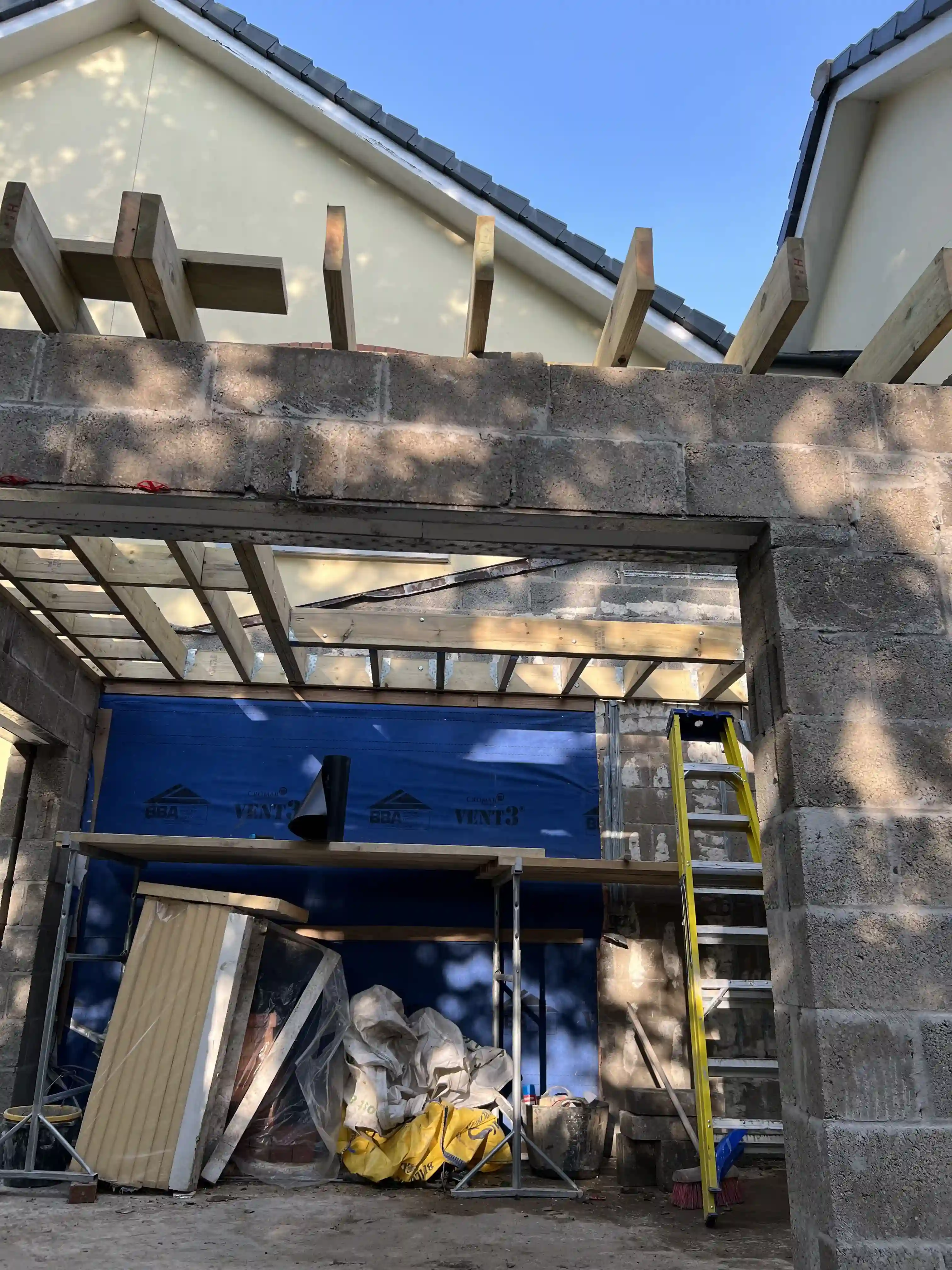 Sunroom extension under construction with timber roof joists at 15 The Links, Peel