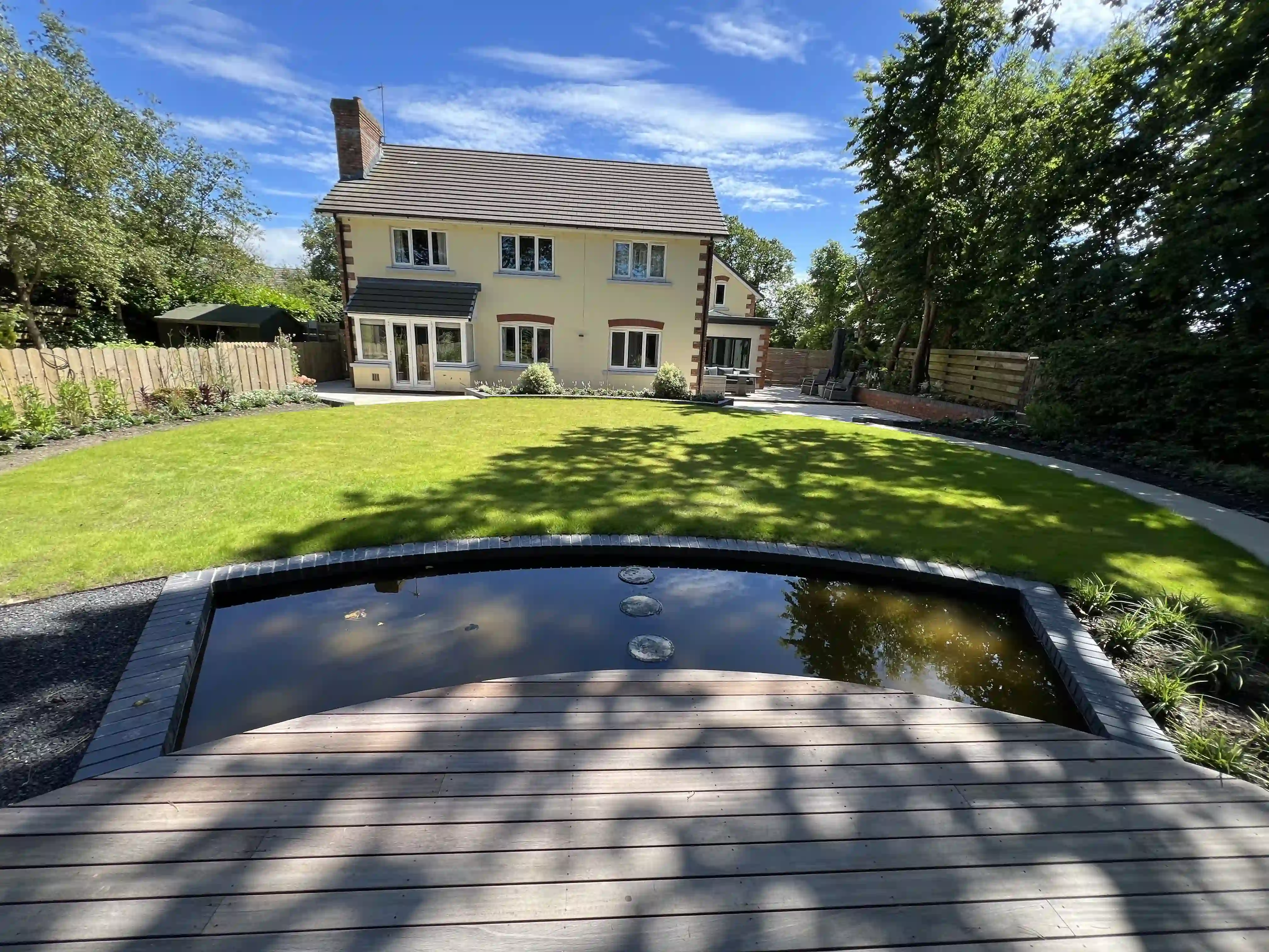 Reflective pool with composite decking in front of the lawn and house at 15 The Links, Peel