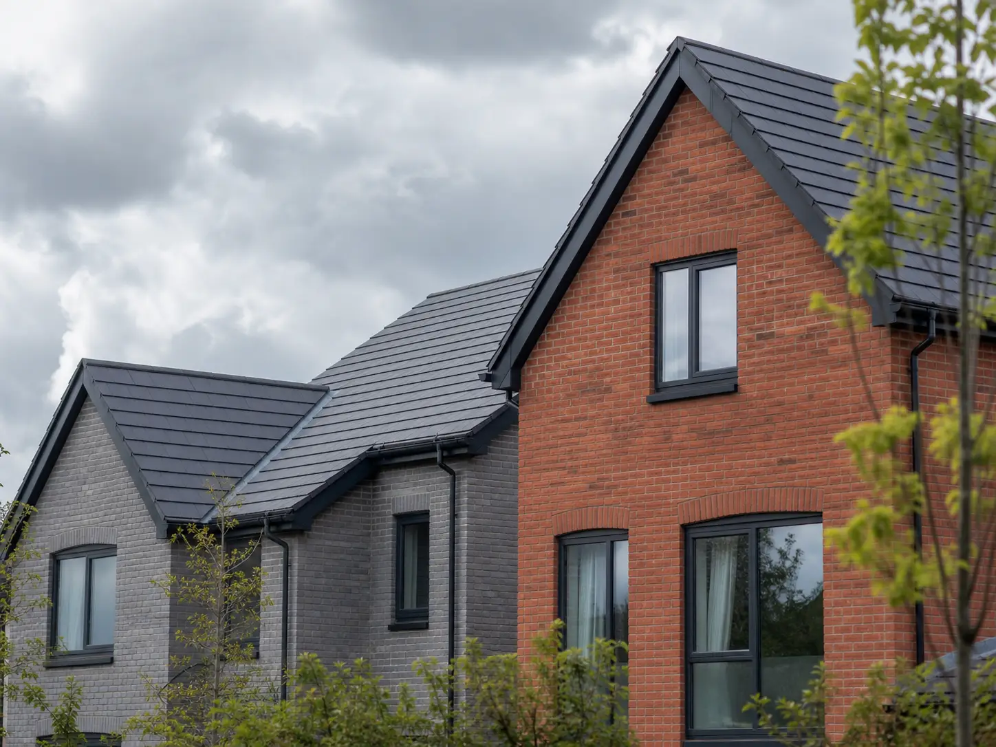 Newly built brick homes with dark tiled roofs