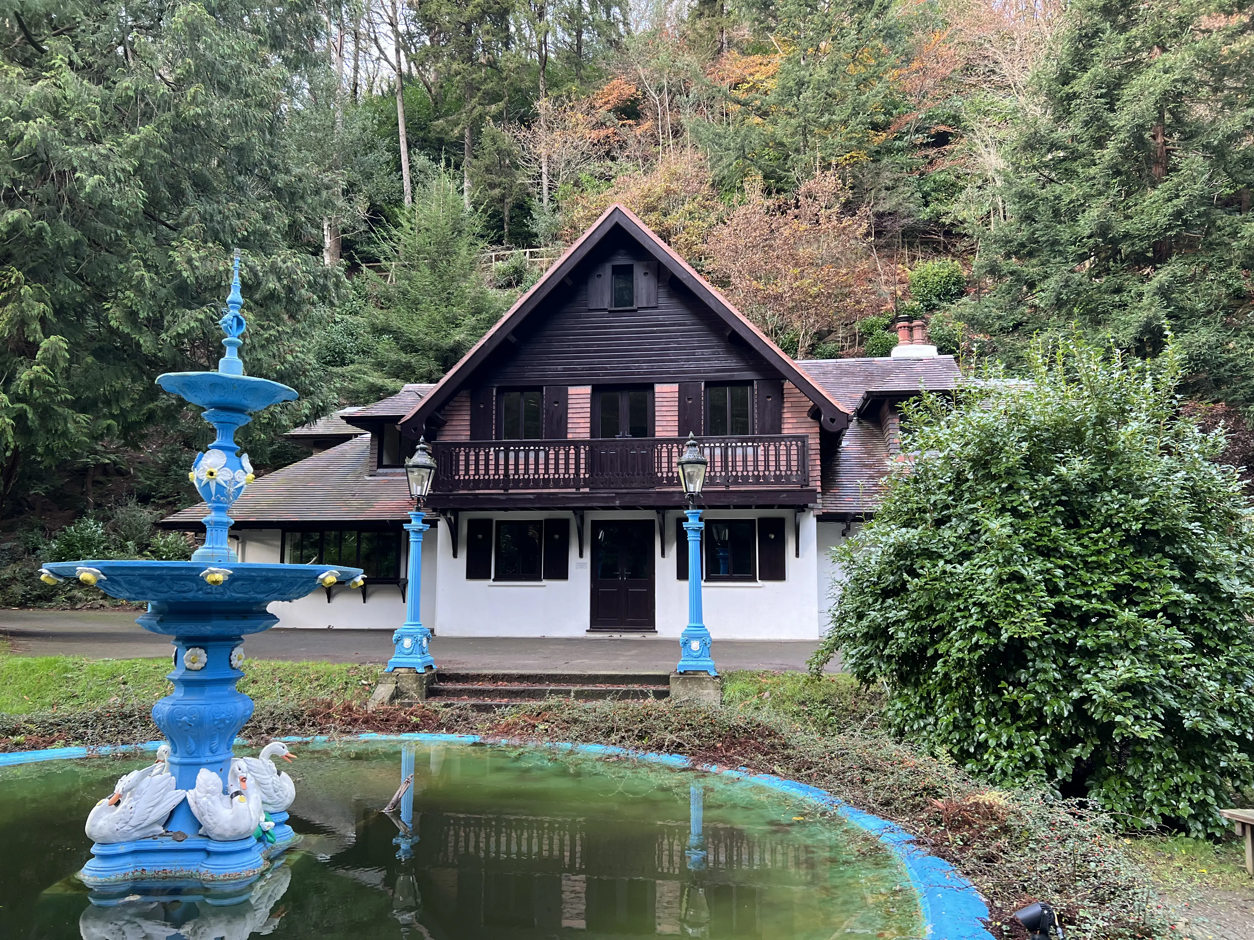 Restored Swiss Chalet at Glen Helen behind the blue ornamental fountain