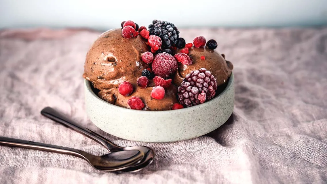 Image of a small Bowl with Chocolate Ice cream topped with frozen berries