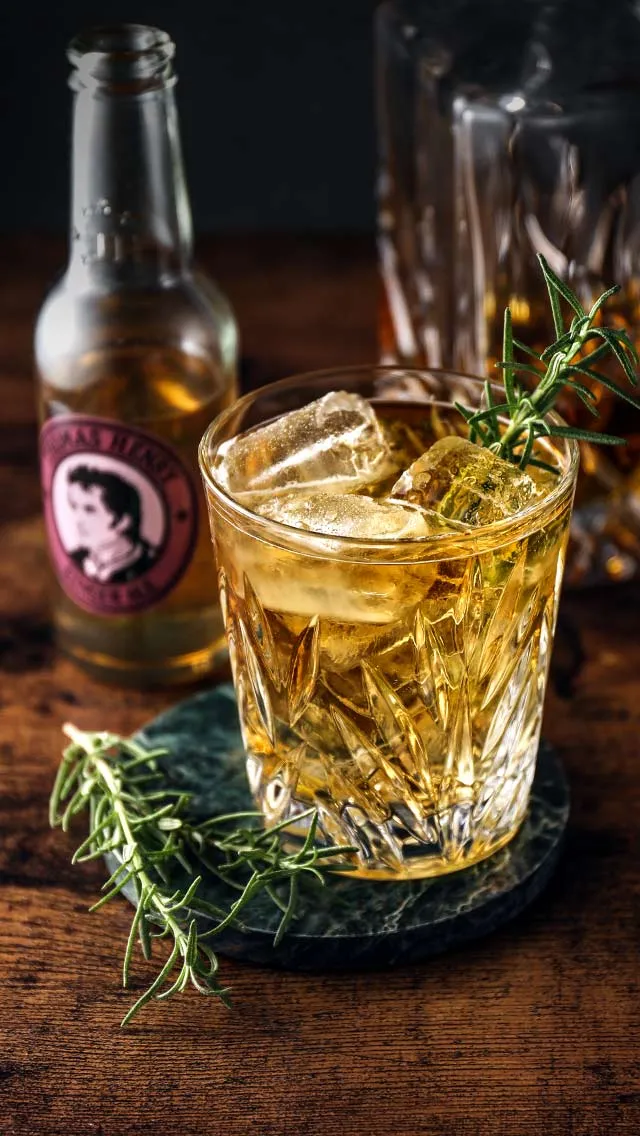 an image of a cocktail with ice and rosmary