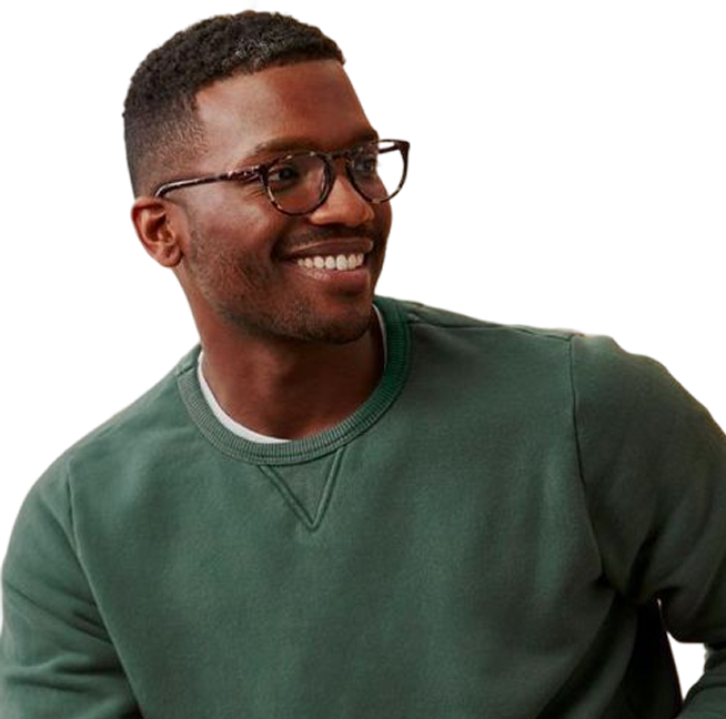 Smiling man wearing glasses and a green crewneck sweatshirt looking to the side.