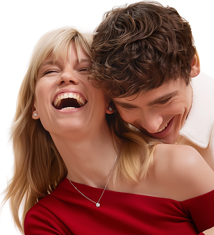 Smiling couple with man leaning on woman’s shoulder, the woman laughing joyfully wearing a red top.