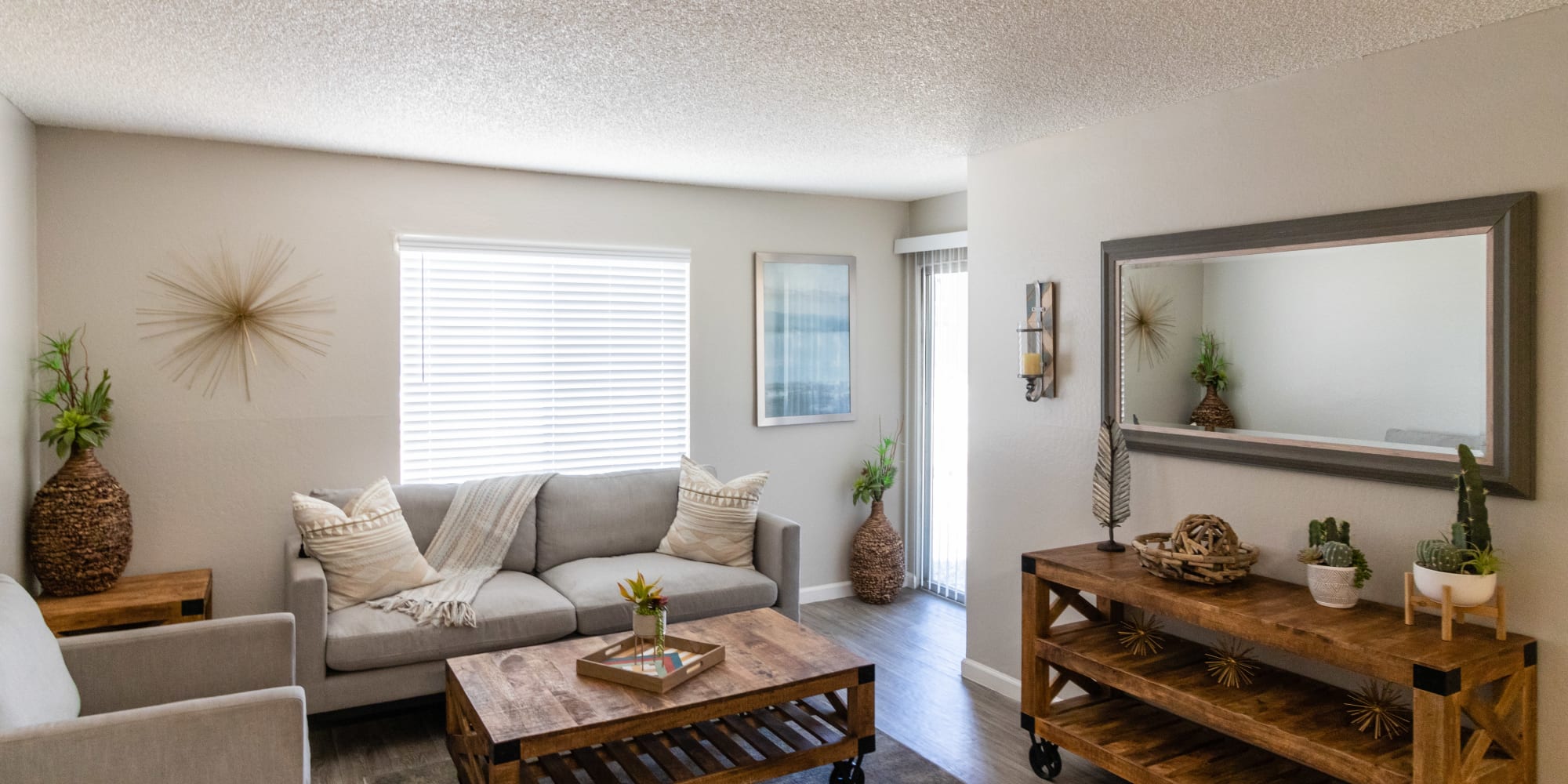 Living area with sofa, coffee table, and large window