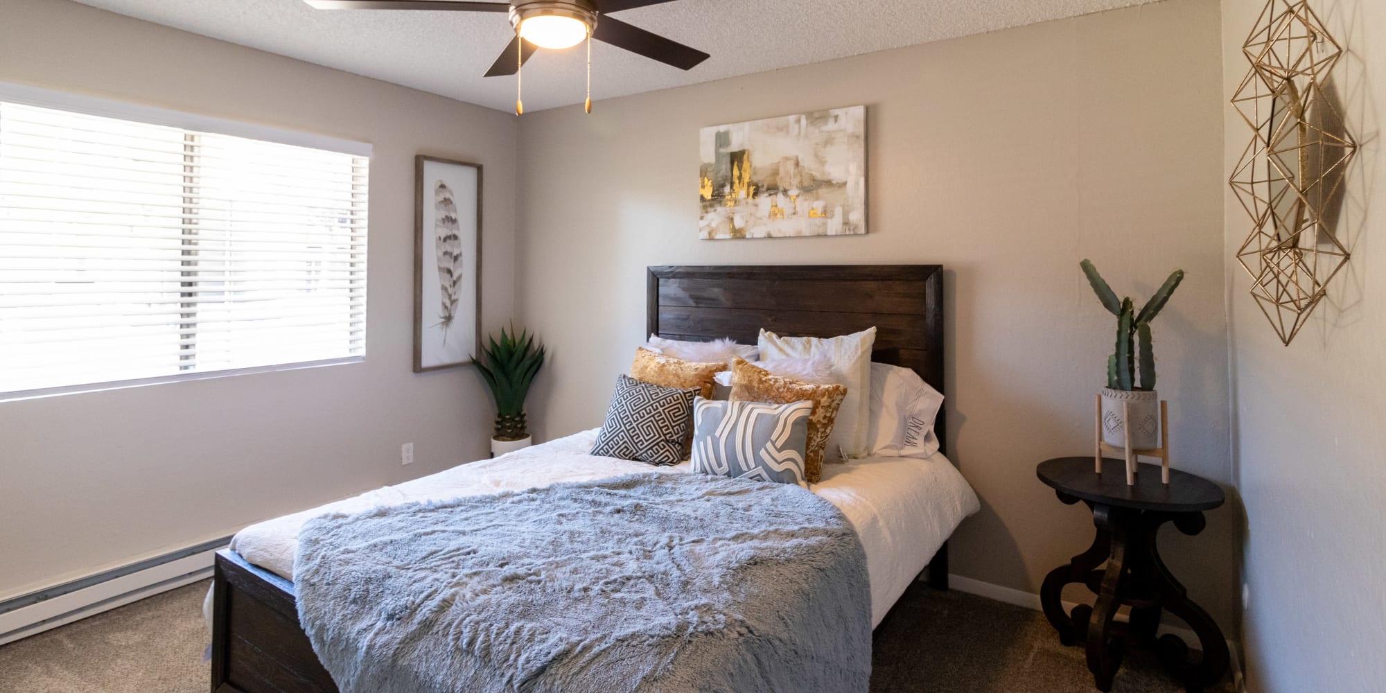 Bedroom with bed large window, and ceiling fan