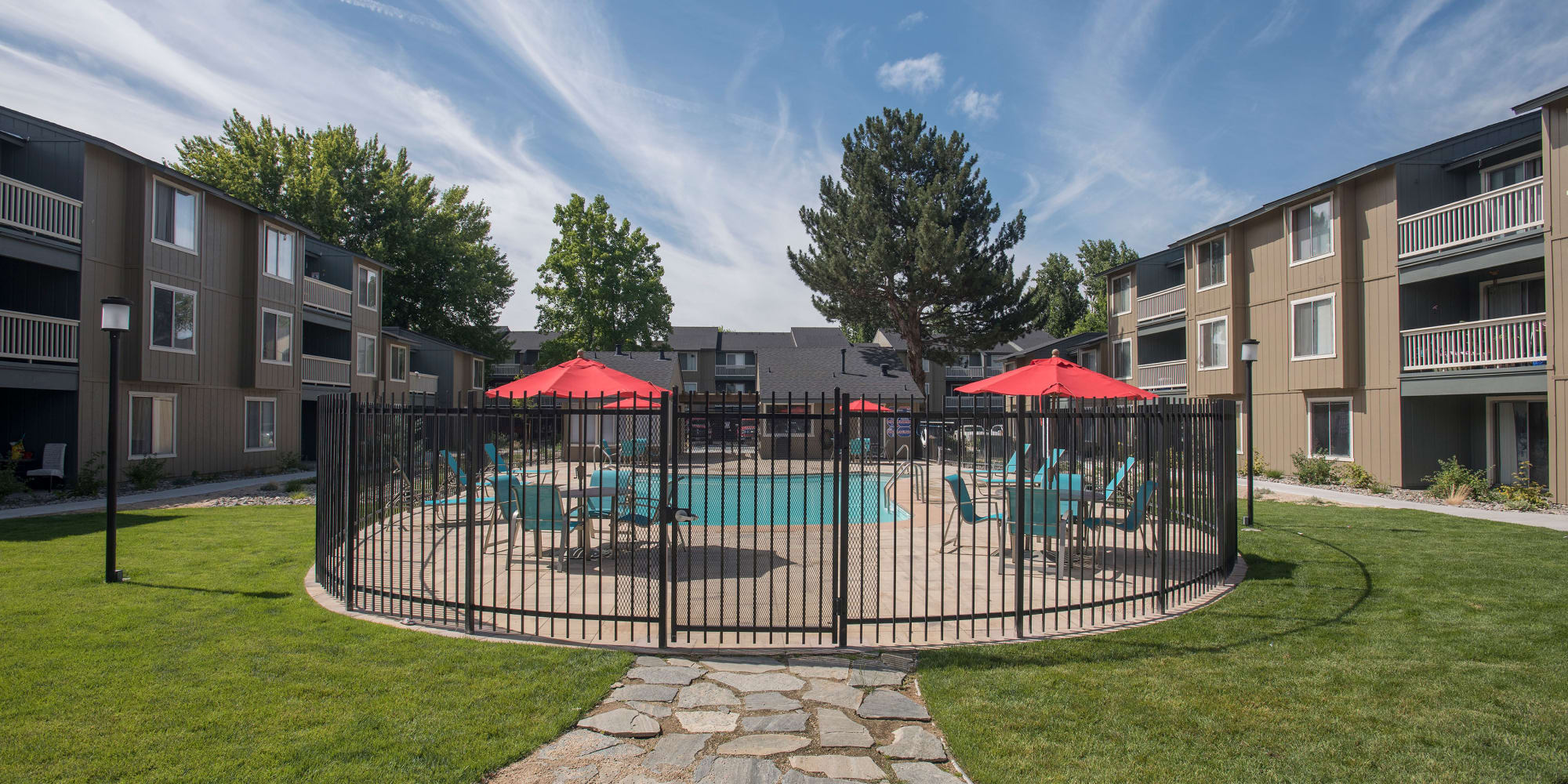 View of swimming pool with tables and umbrellas