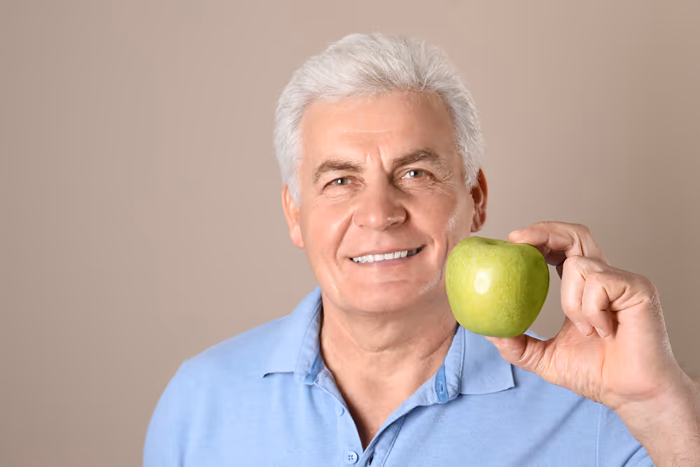 Person smiling and eating comfortably after dental implant treatment