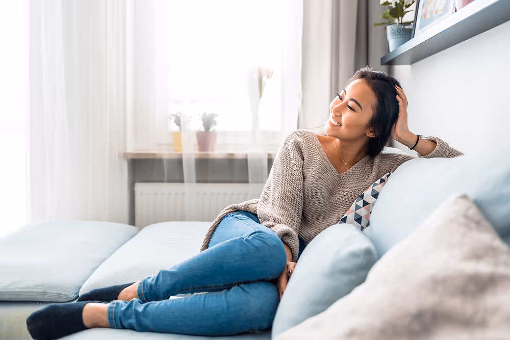 Patient resting comfortably at home after dental implant surgery