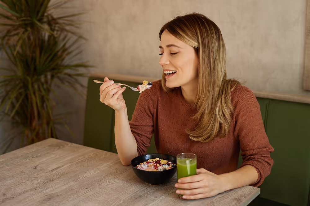 Person enjoying a soft, healthy meal while recovering from implant surgery