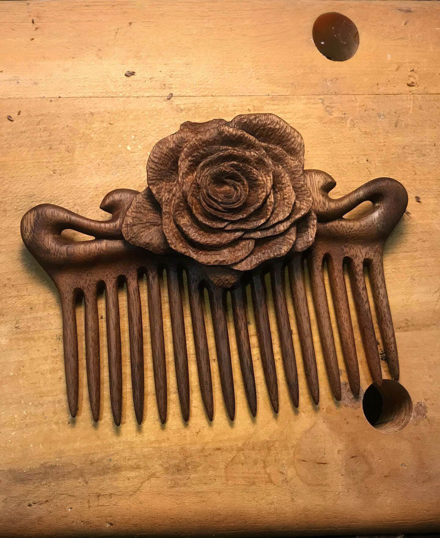 A photo of a rose hair comb I carved.