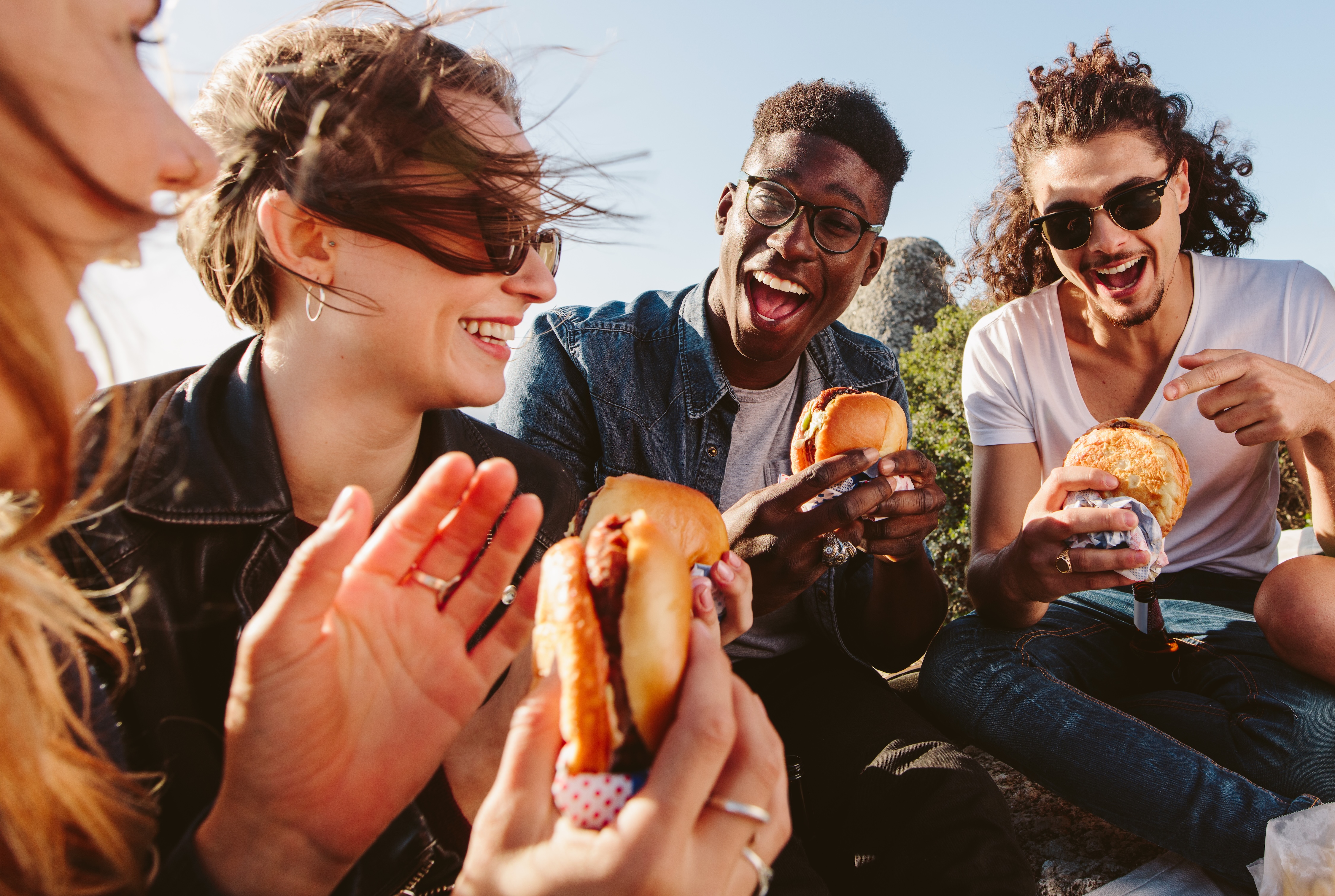 Friends eating burgers stock photo
