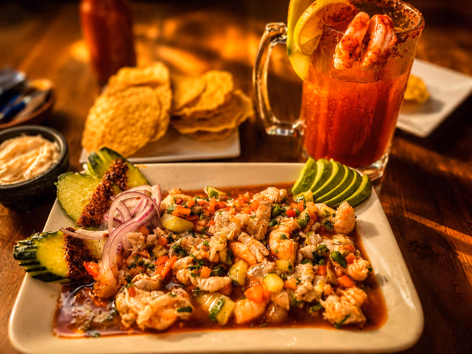 A plate of food with a drink on the table.