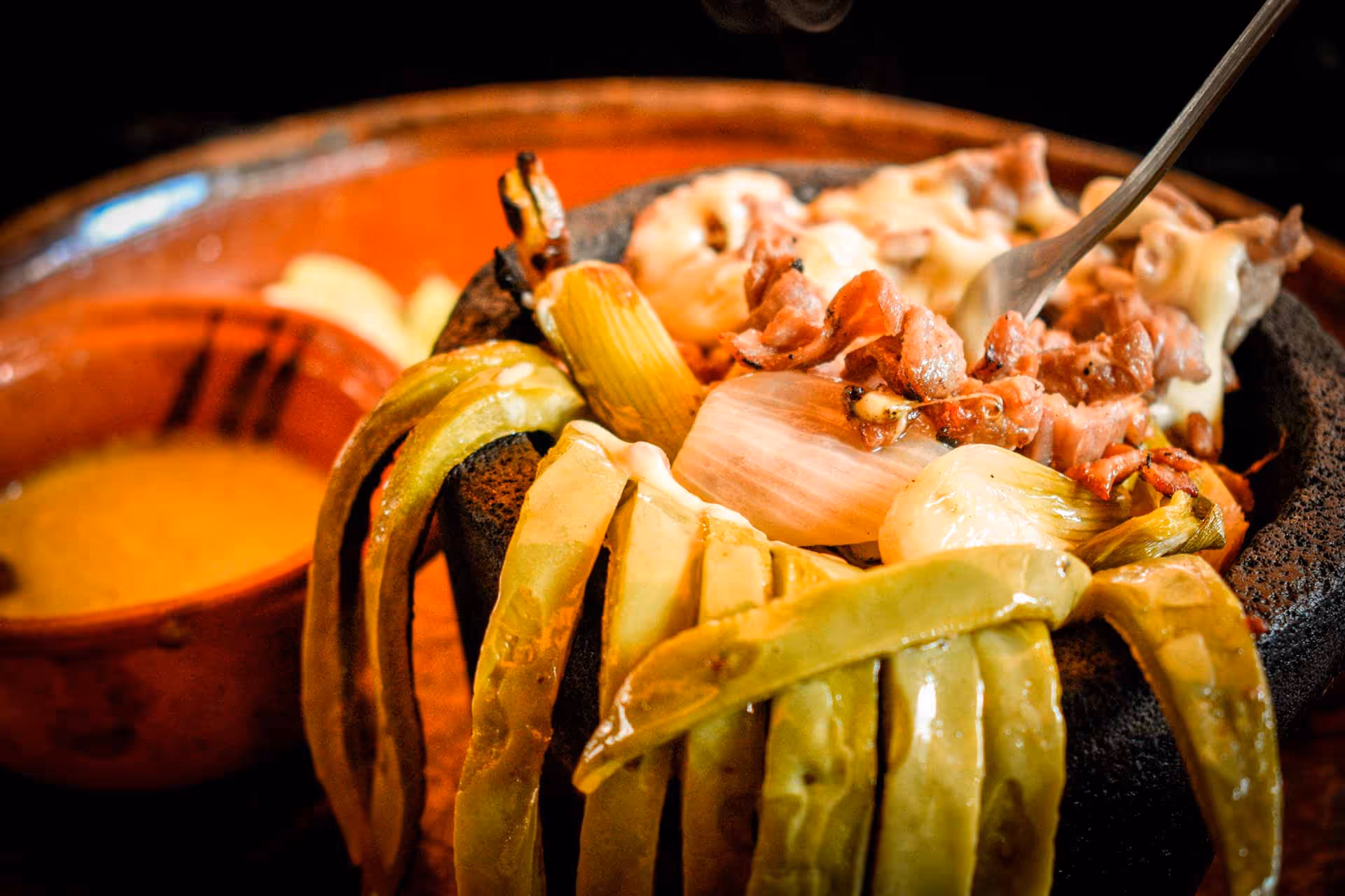 A bowl of food with a spoon in it.
