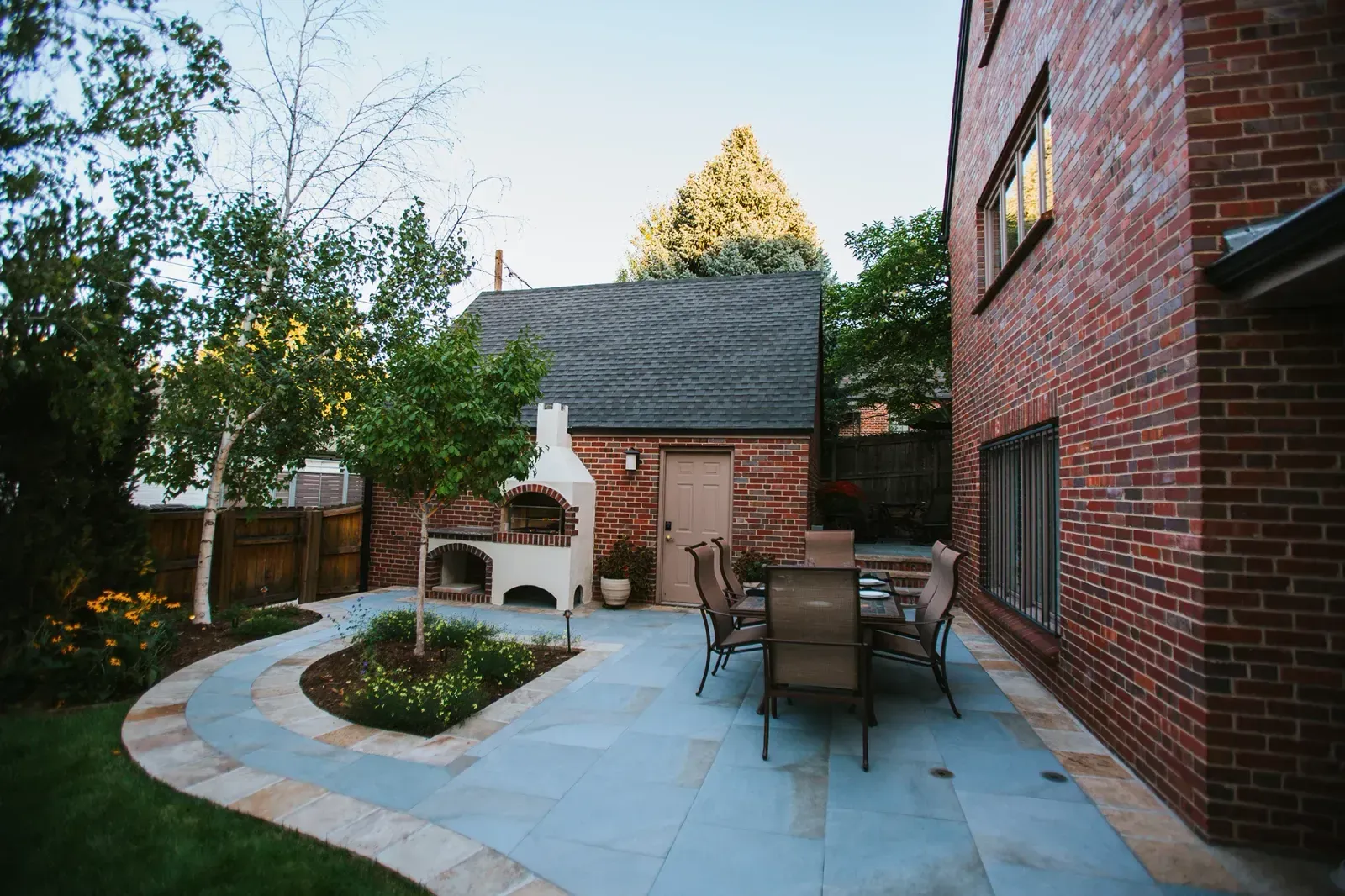 Modern outdoor patio that matches a brick wall home finish