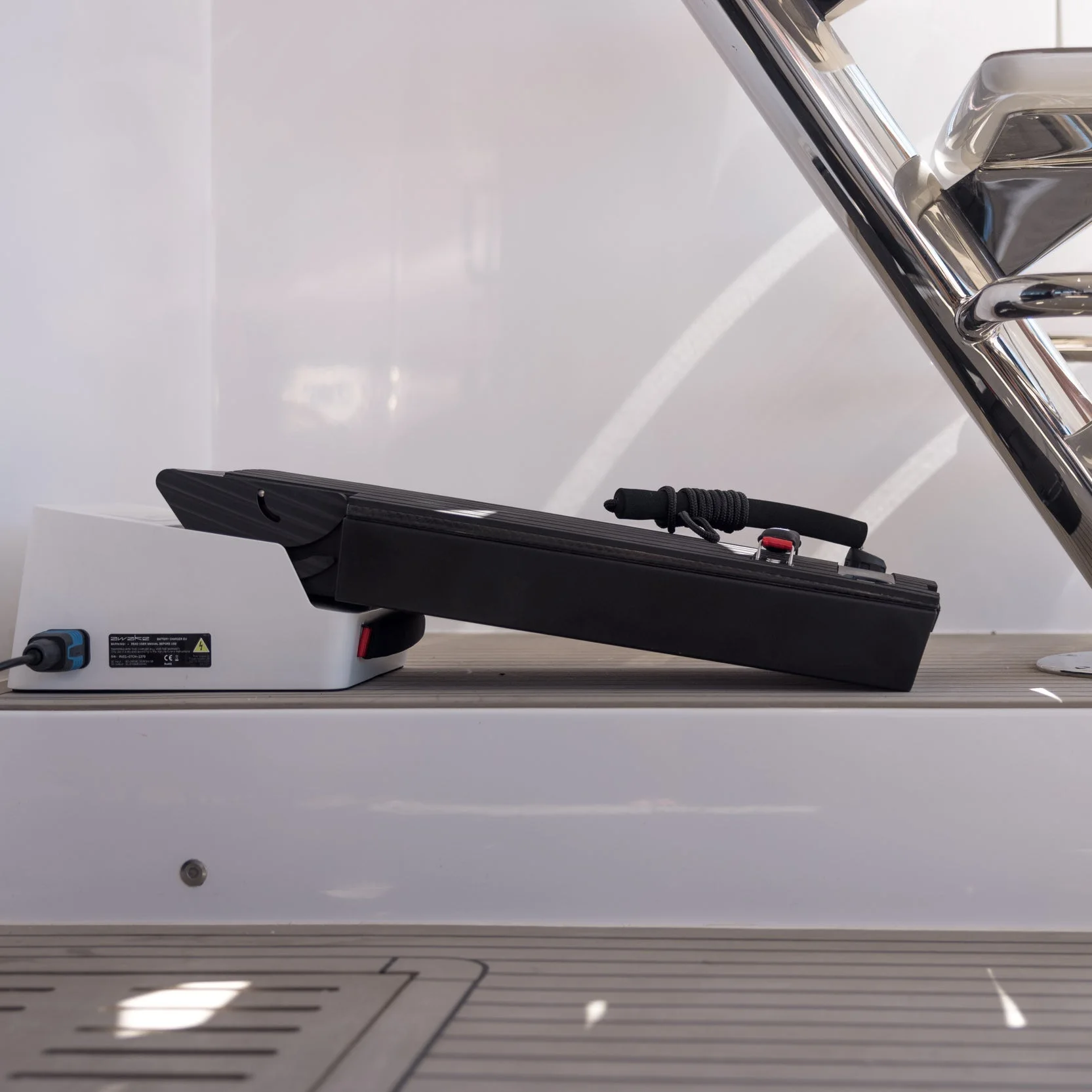 Electric surfboard battery in a yacht garage hatch