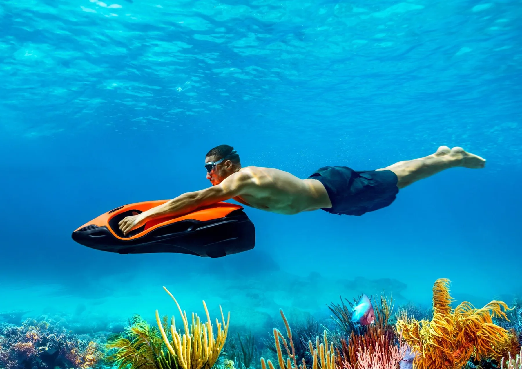Diver riding a SEABOB over a reef