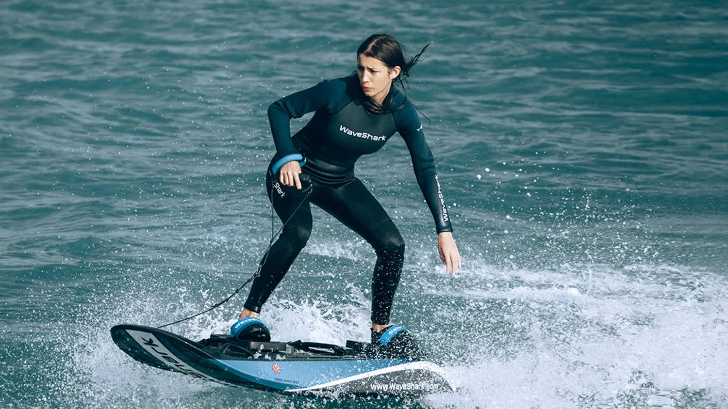 Rider carving on an electric surfboard
