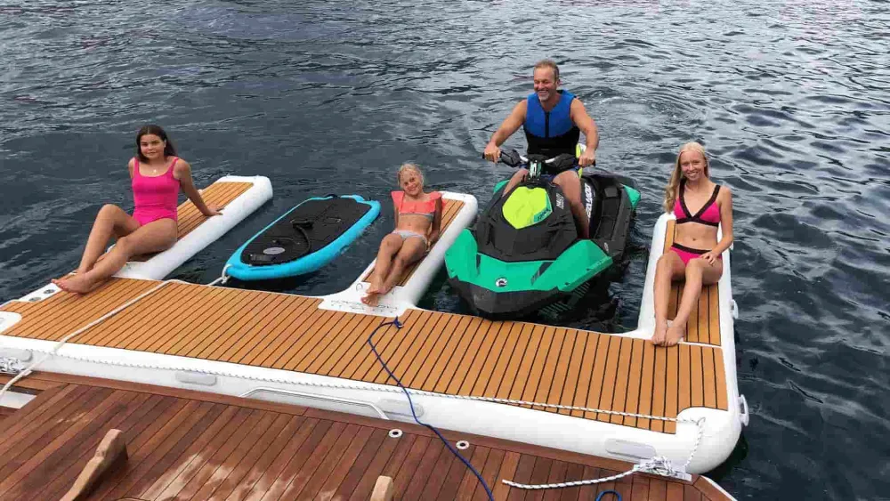 Guests on a YACHTBEACH jet ski dock with a PWC and electric board