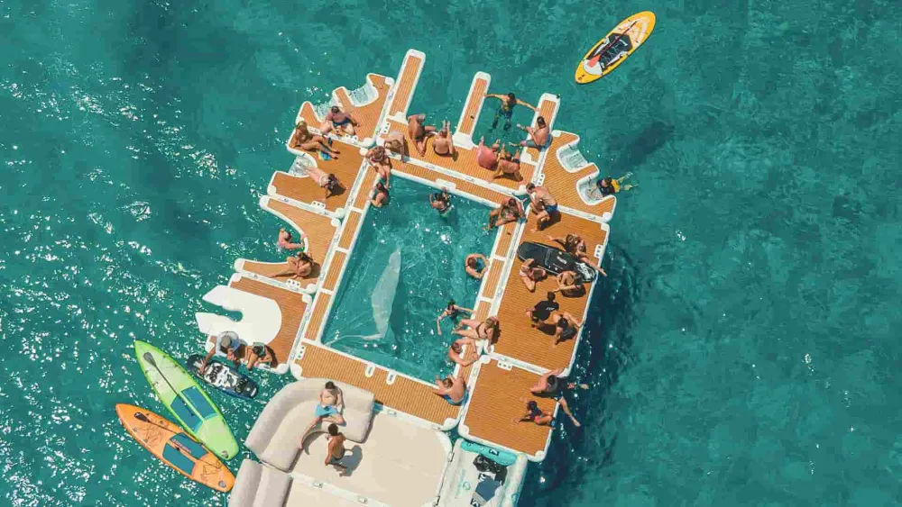 YACHTBEACH Luxury Pool off a yacht with guests swimming inside