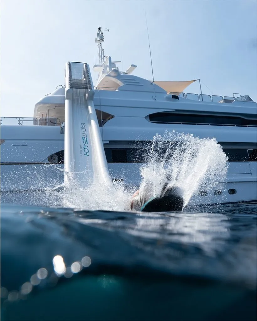 YACHTBEACH Magic Yachtslide splashing down off a superyacht