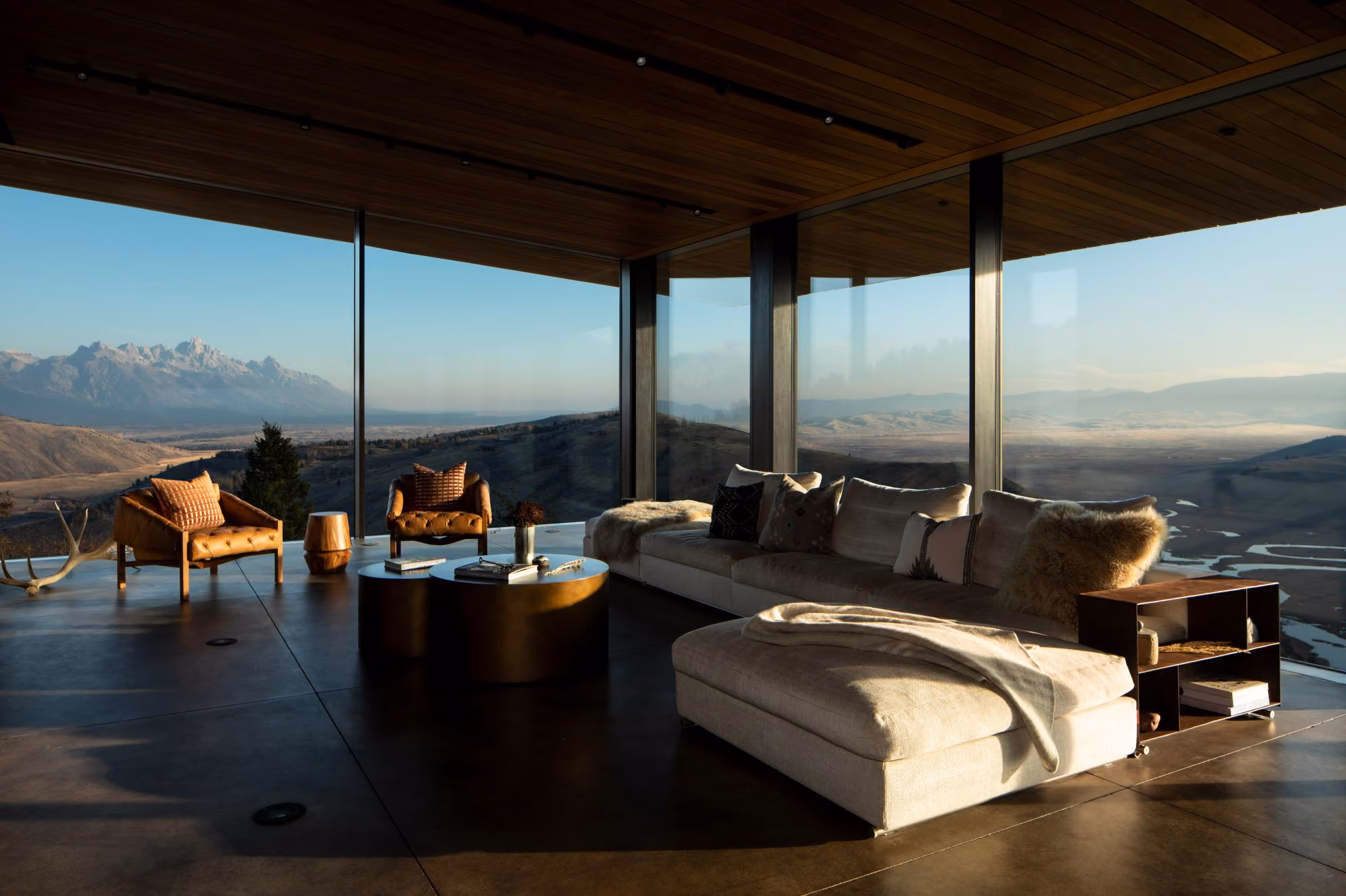 Glass-wrapped living area in Saddle Butte, a custom luxury home