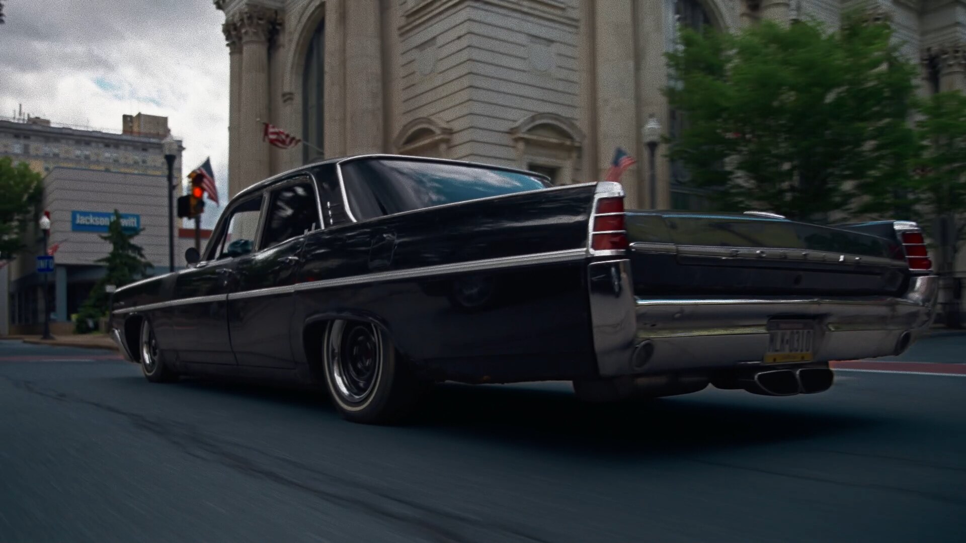 The Star Chief, black 1963 Pontiac rolling downtown