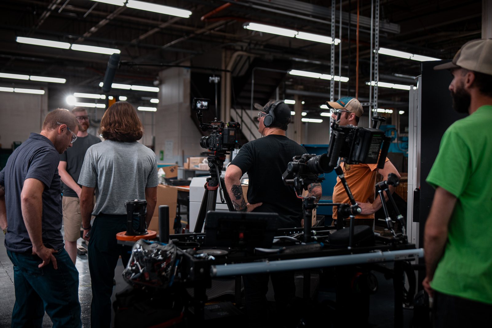 DMK crew filming with a rig on the cylinder department floor