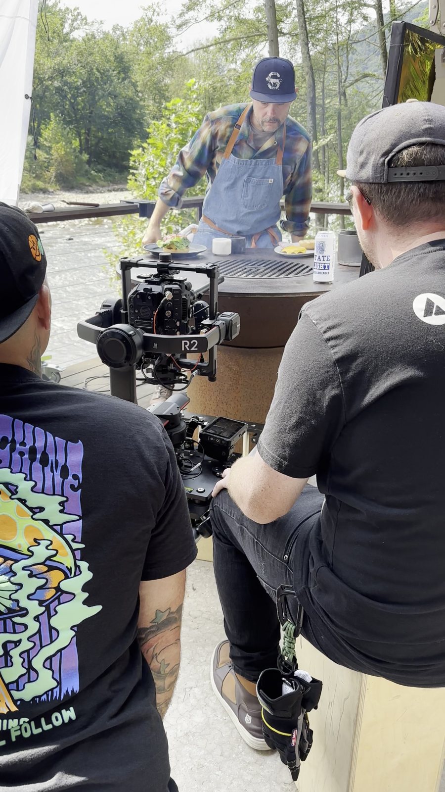 Crew filming the chef at the grill, behind the scenes
