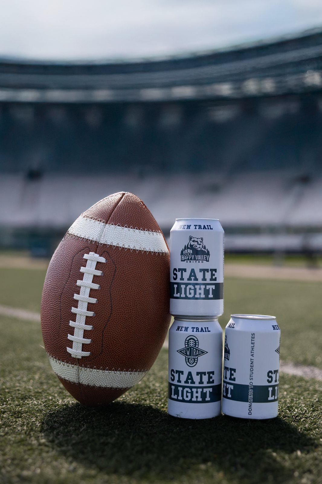 State Light 15-pack and football on the field at Beaver Stadium