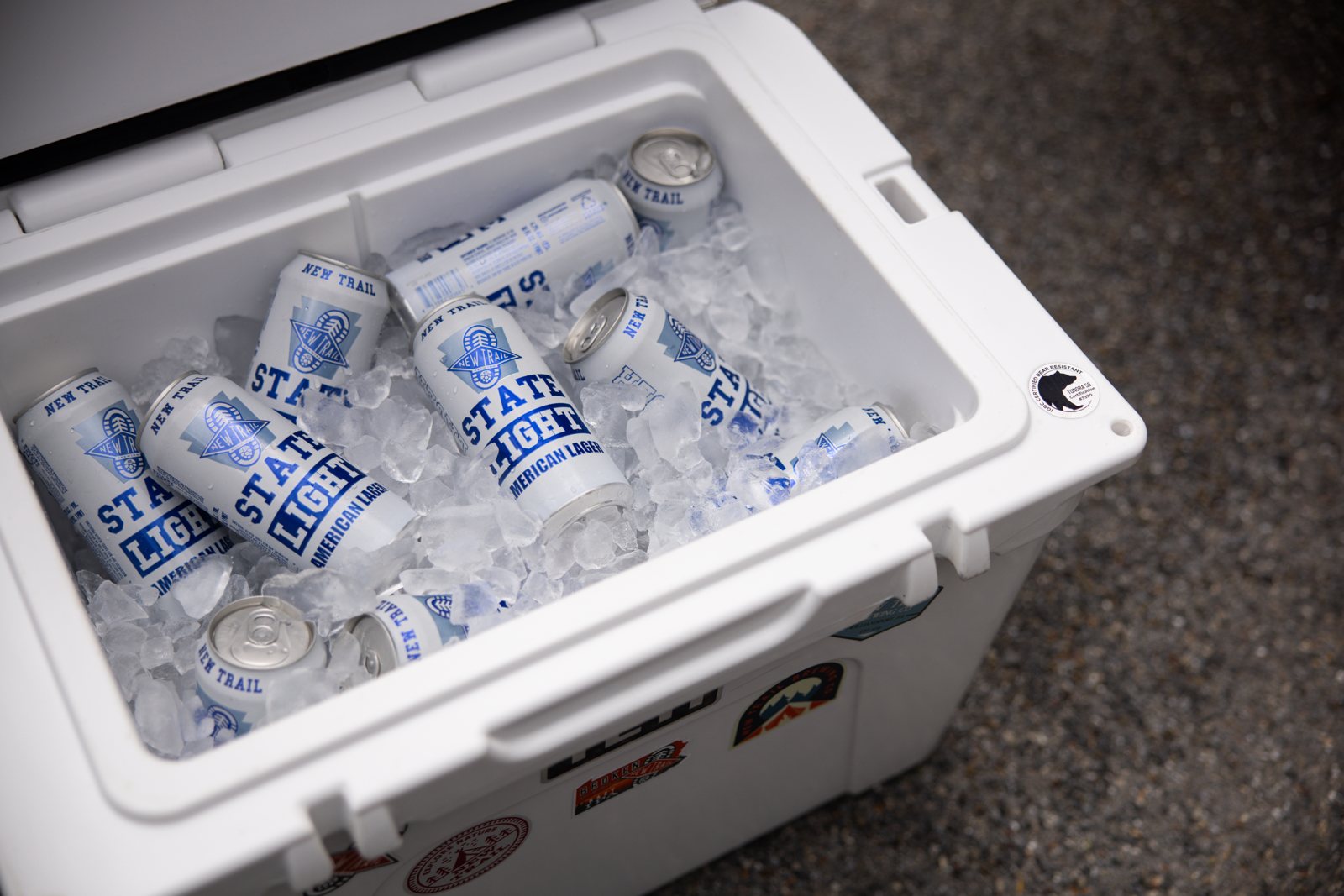 Cooler packed with State Light cans on ice