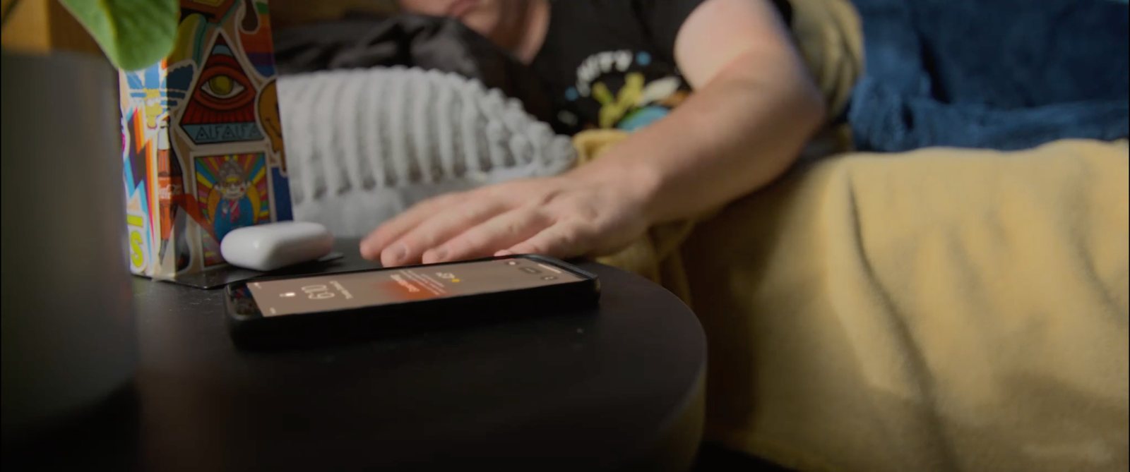 Student hits the alarm on a phone in a dorm room