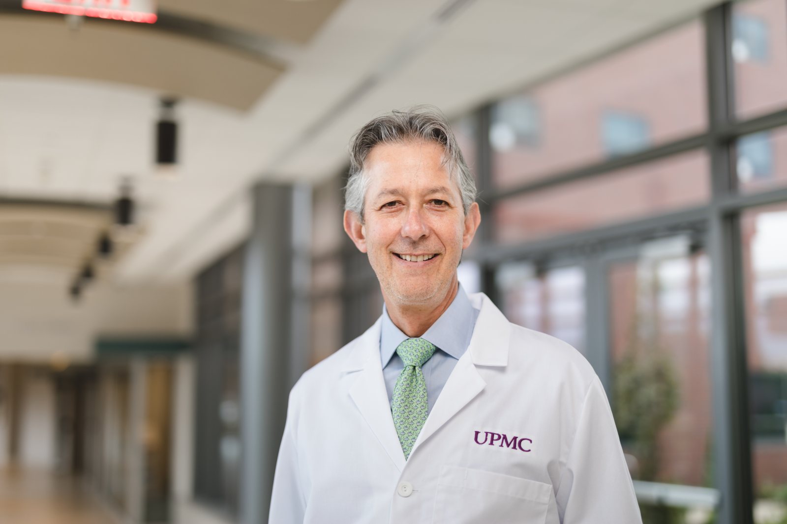UPMC physician in a white coat in a hospital corridor