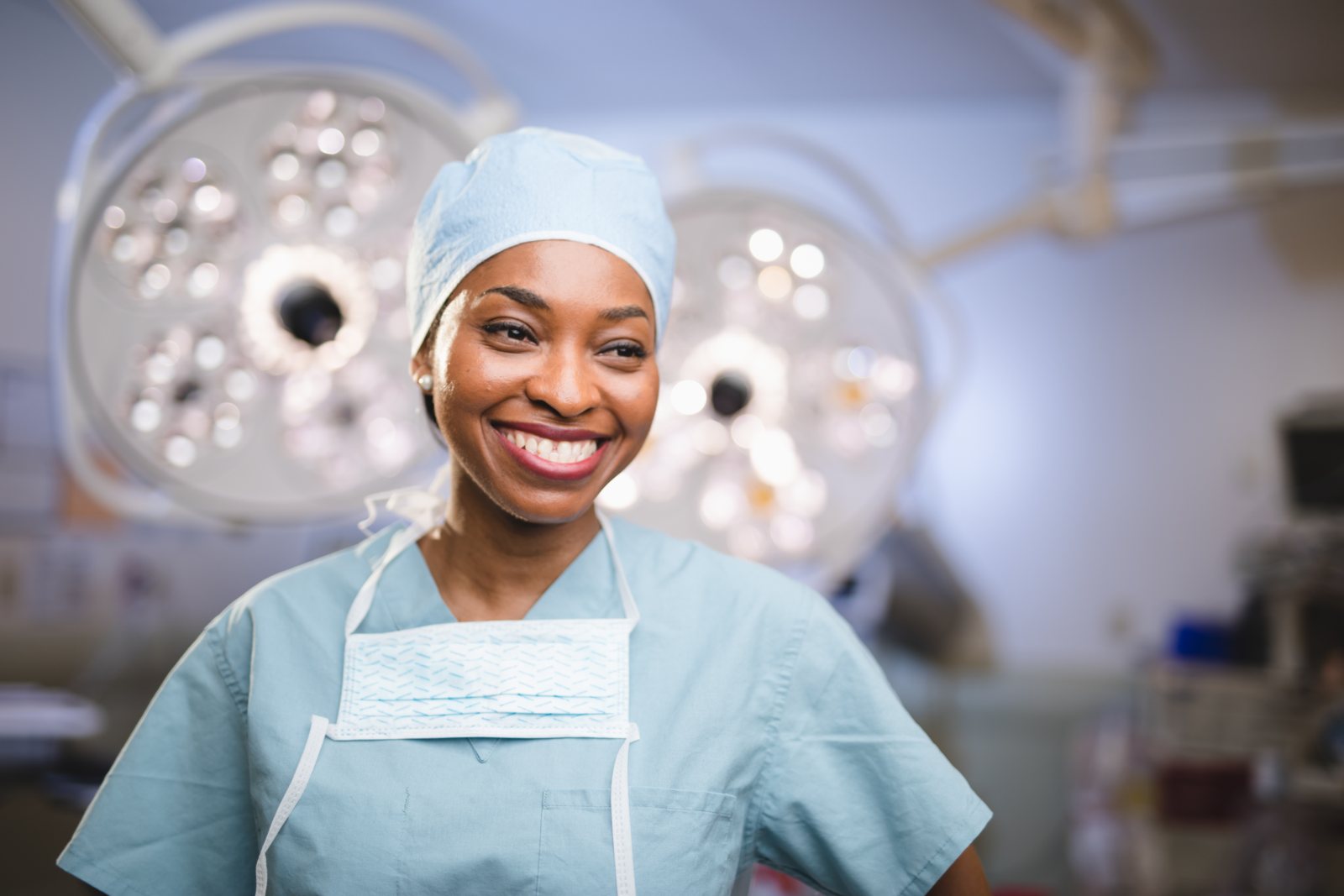 UPMC surgeon portrait in scrubs under OR lights