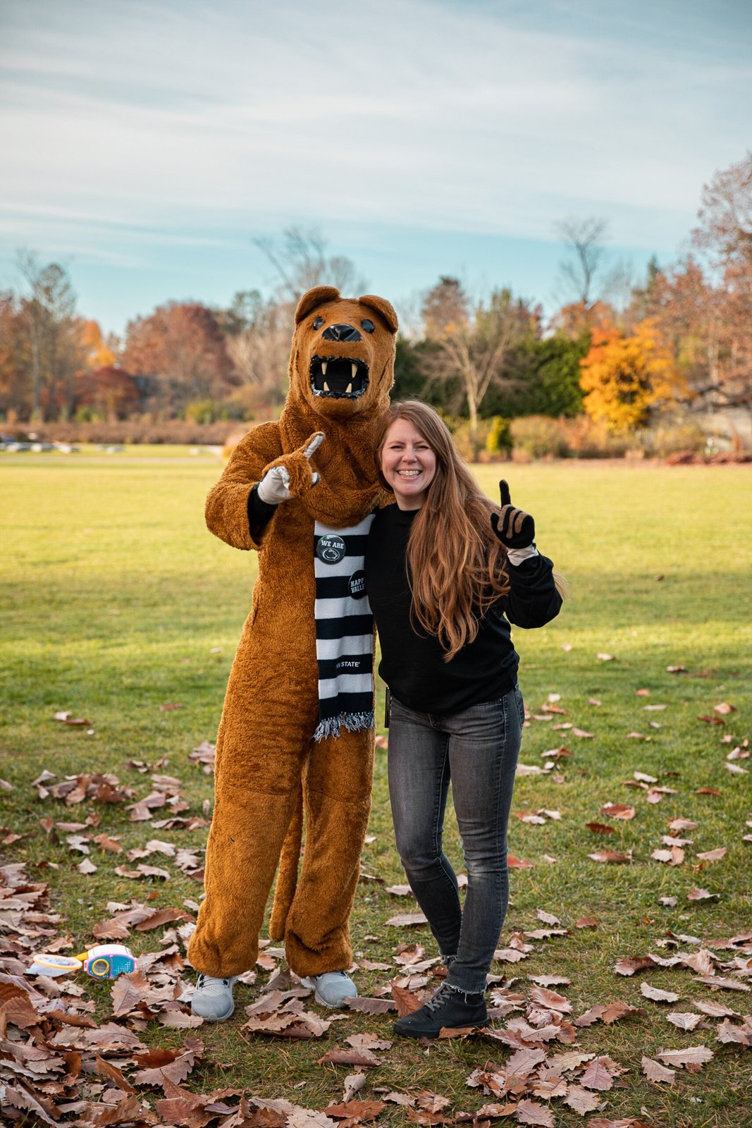 The Nittany Lion with a student on the Arboretum path