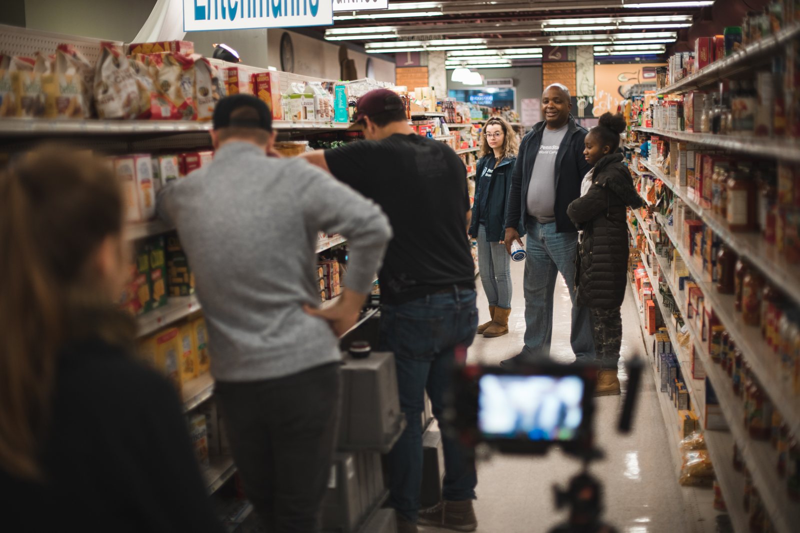 Crew filming in a grocery store aisle
