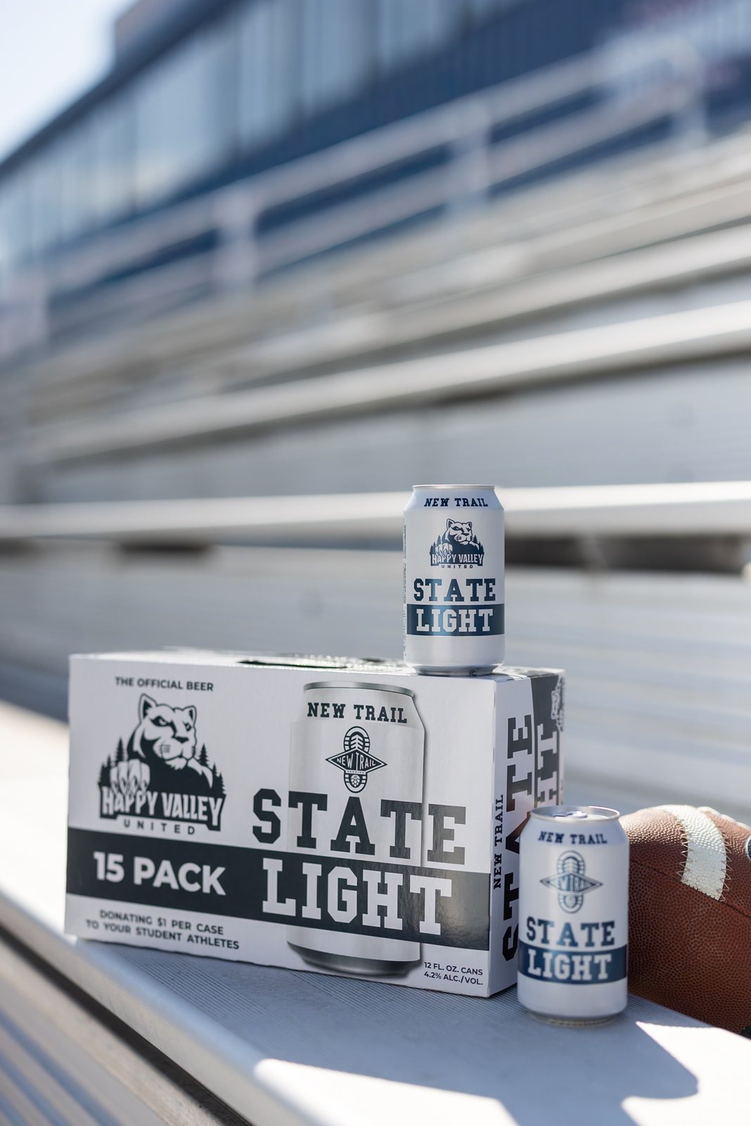 State Light 15-pack and cans on the stadium bleachers with a football